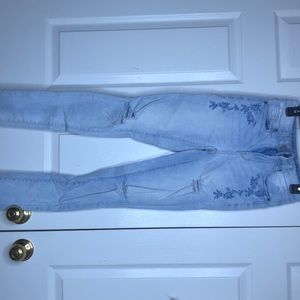 light wash jeans with flower decor